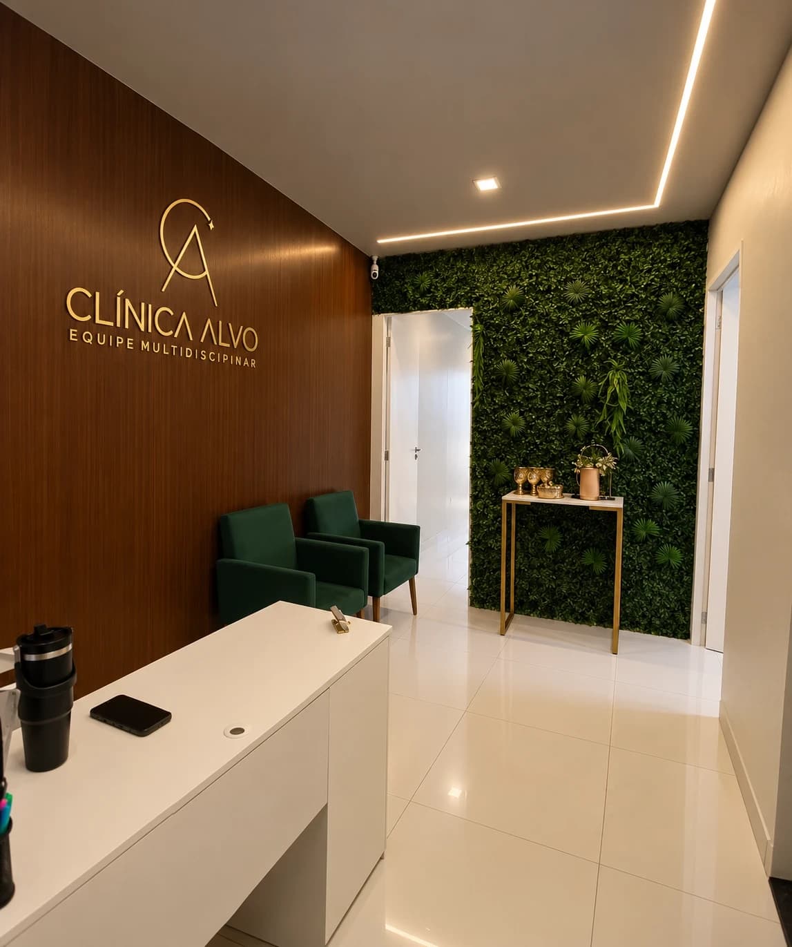 Recepção da Clínica Alvo: letreiro dourado na parede de madeira, poltronas verdes e jardim vertical